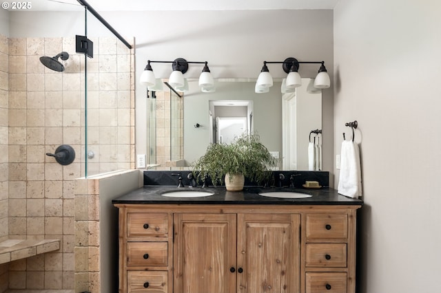 full bathroom featuring tiled shower and double vanity