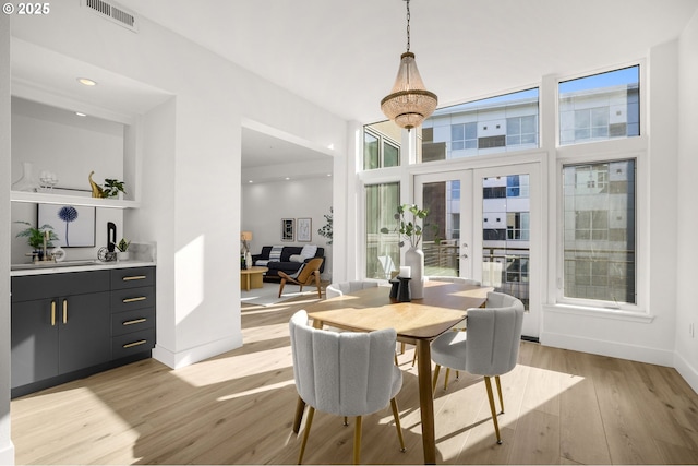 dining area with french doors and light wood-type flooring