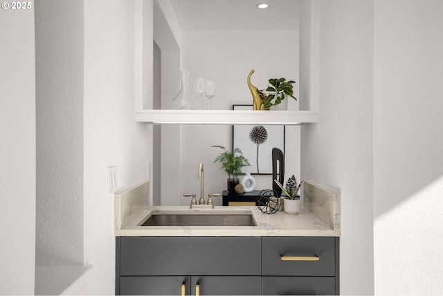 bar with gray cabinets and sink