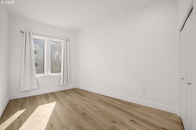 spare room featuring light wood-type flooring