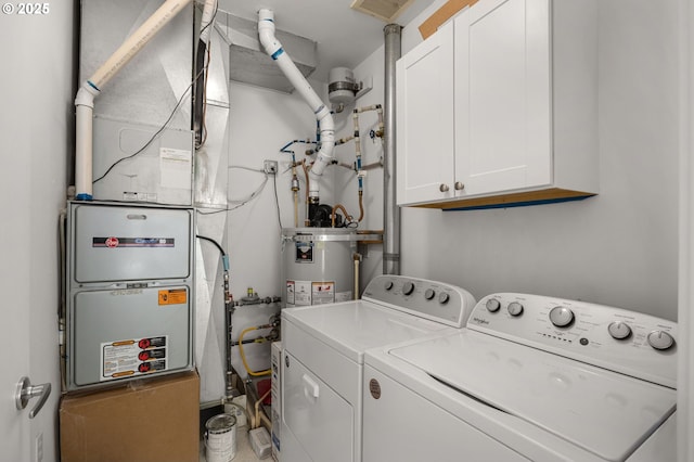 clothes washing area featuring cabinets, separate washer and dryer, and gas water heater