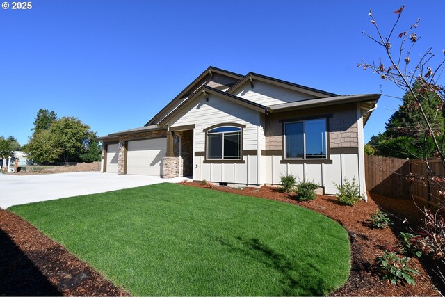 view of front of home with a front yard and a garage