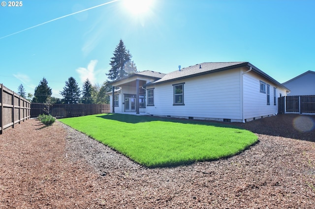 rear view of house featuring a yard