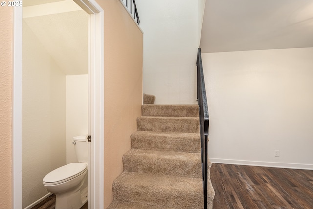 stairs with baseboards and wood finished floors