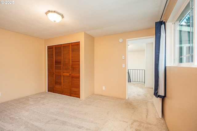 unfurnished bedroom featuring carpet floors and a closet