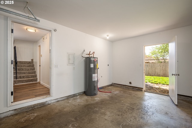 garage with baseboards and water heater