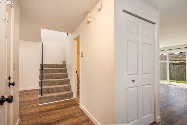 stairway with baseboards and wood finished floors