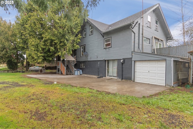 exterior space featuring a garage, a yard, and a patio area