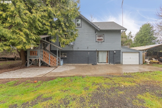 view of front of home with a garage and stairs