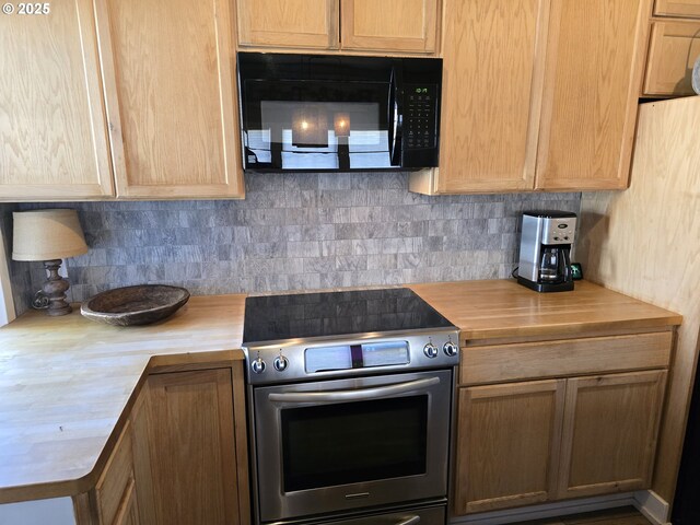 208 Acacia Ave, Garibaldi, OR 97118 - kitchen with butcher block countertops, electric range, black microwave, and decorative backsplash