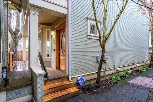 view of exterior entry with covered porch