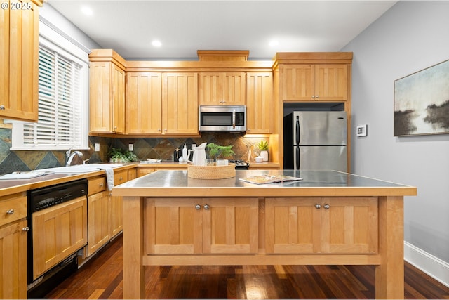 kitchen with a kitchen island, backsplash, dark hardwood / wood-style flooring, stainless steel counters, and stainless steel appliances