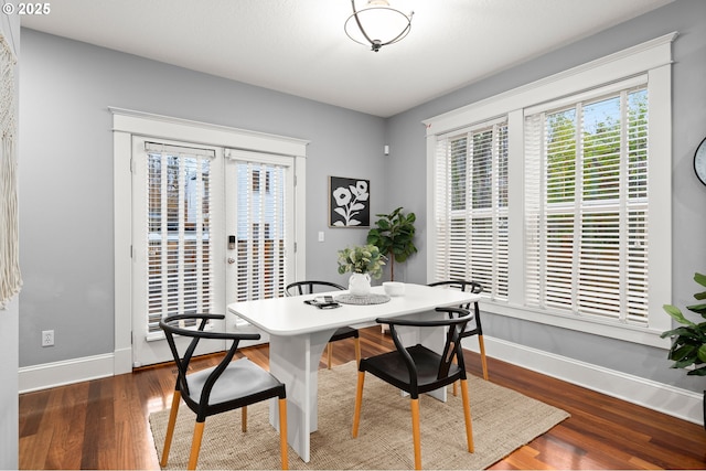 dining room featuring dark hardwood / wood-style flooring and french doors