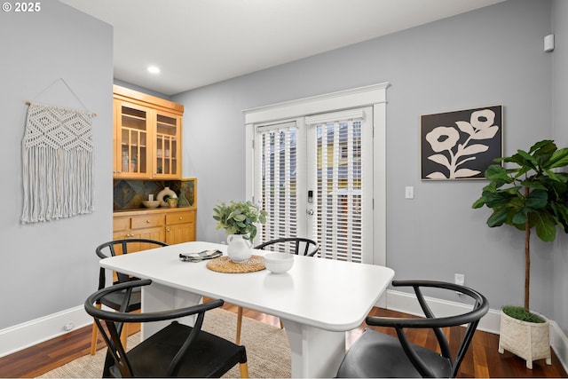 dining area with wood-type flooring and french doors