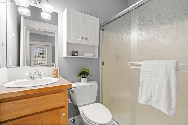 bathroom with vanity, toilet, and walk in shower