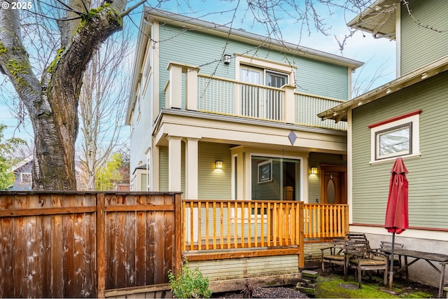 rear view of property featuring a balcony