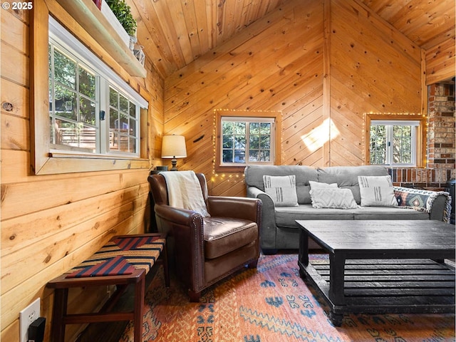 sitting room with wooden walls, a wealth of natural light, wood ceiling, and wood finished floors