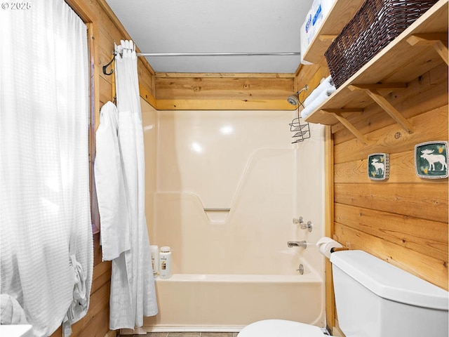 full bathroom with shower / bath combo with shower curtain and toilet