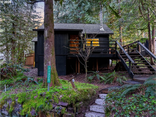 view of outbuilding featuring stairs