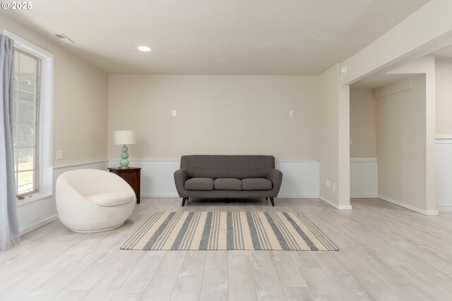 living room featuring a fireplace, light hardwood / wood-style floors, and a textured ceiling