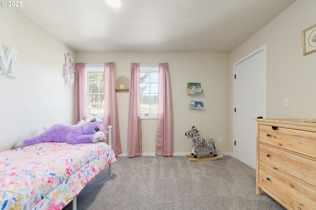 unfurnished bedroom with light carpet and a closet