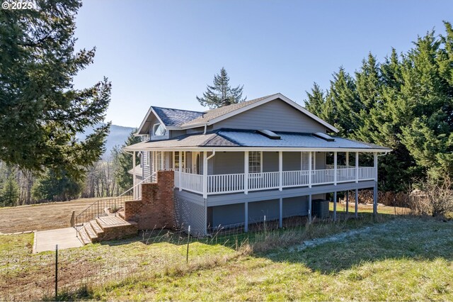 view of front of house featuring a garage, a front yard, and a porch