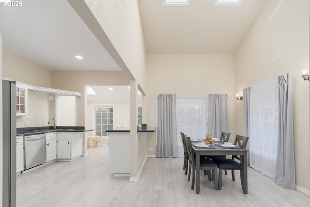 living room with beamed ceiling, wood-type flooring, and a high ceiling