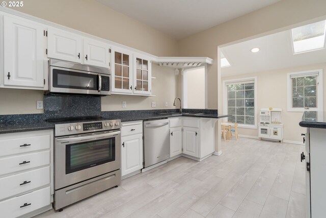 dining room with sink and light hardwood / wood-style flooring