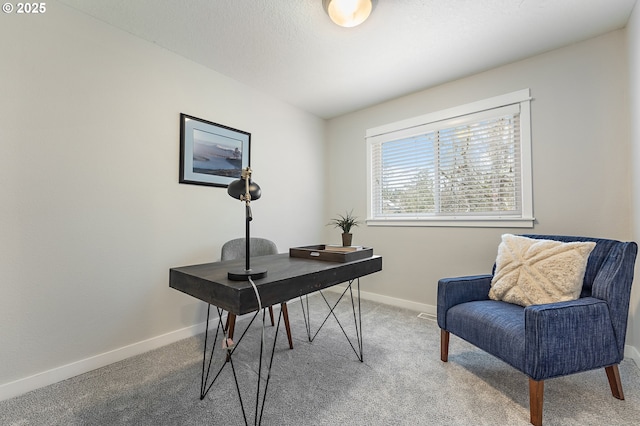 carpeted office featuring baseboards