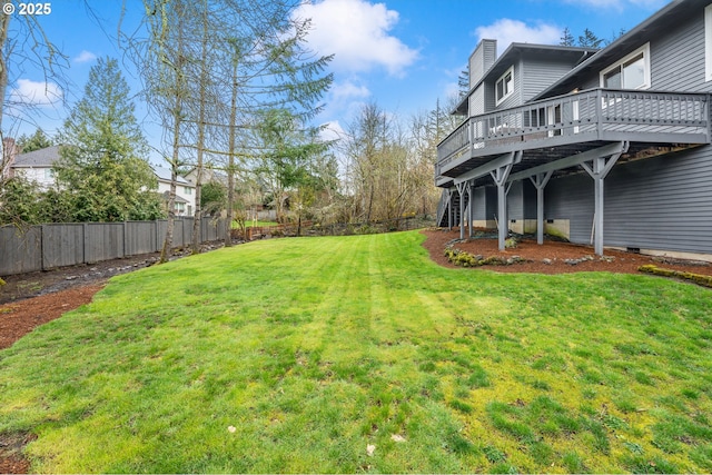 view of yard with a deck, stairway, and a fenced backyard