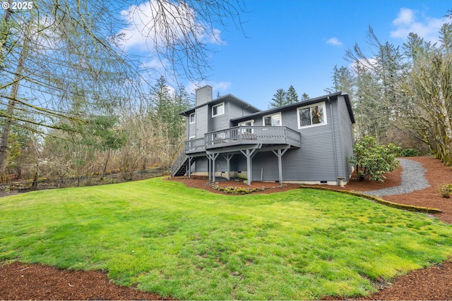 back of property with a lawn, a chimney, fence, a wooden deck, and stairs