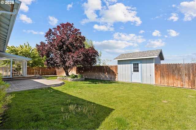 view of yard featuring a shed, an outbuilding, and a deck