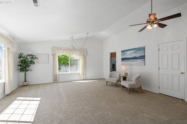 unfurnished room with lofted ceiling, carpet floors, ceiling fan, and baseboards