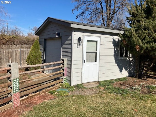 view of outbuilding with an outbuilding and fence