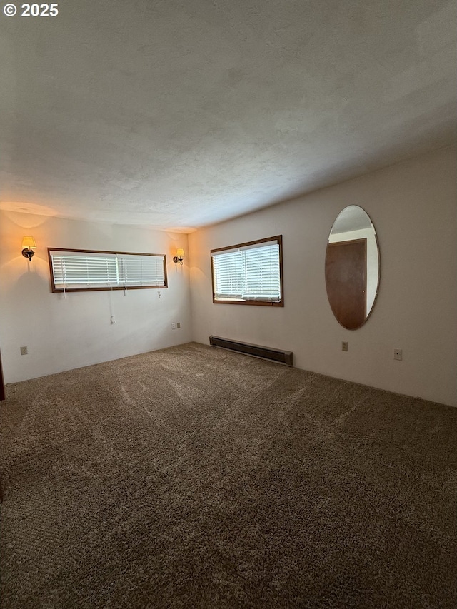 31431 Fairview Rd, Rainier, OR 97048 - empty room featuring a baseboard heating unit and carpet