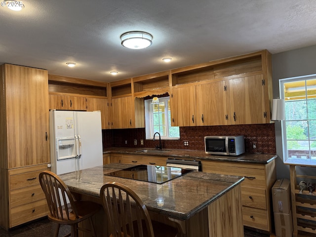 31431 Fairview Rd, Rainier, OR 97048 - kitchen with white refrigerator with ice dispenser, a sink, stainless steel microwave, backsplash, and open shelves