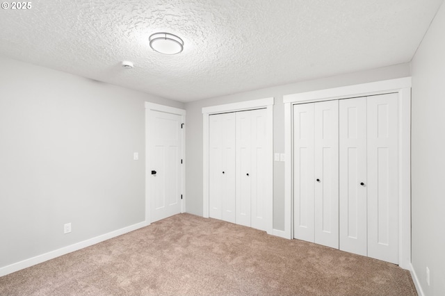 18240 SW Jay St, Beaverton, OR 97003 - unfurnished bedroom featuring two closets, carpet, and a textured ceiling