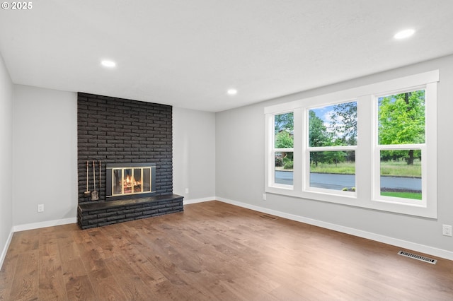 18240 SW Jay St, Beaverton, OR 97003 - unfurnished living room featuring wood finished floors, a brick fireplace, and recessed lighting