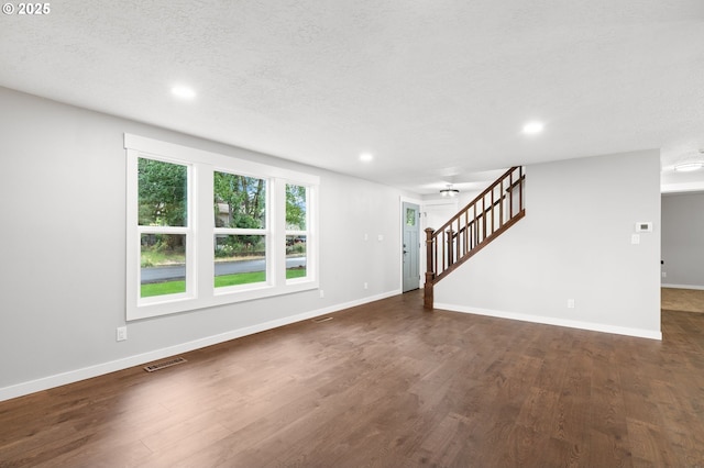 18240 SW Jay St, Beaverton, OR 97003 - unfurnished living room featuring dark wood-type flooring, recessed lighting, stairway, and a textured ceiling