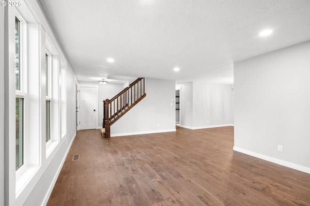 18240 SW Jay St, Beaverton, OR 97003 - unfurnished living room featuring stairway, recessed lighting, wood finished floors, and plenty of natural light