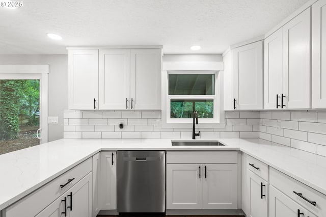 18240 SW Jay St, Beaverton, OR 97003 - kitchen with dishwasher, a textured ceiling, decorative backsplash, recessed lighting, and white cabinetry