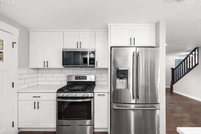 18240 SW Jay St, Beaverton, OR 97003 - kitchen featuring stainless steel appliances, light countertops, tasteful backsplash, white cabinetry, and a textured ceiling