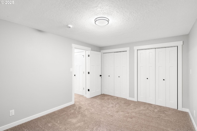18240 SW Jay St, Beaverton, OR 97003 - unfurnished bedroom with multiple closets, carpet, and a textured ceiling