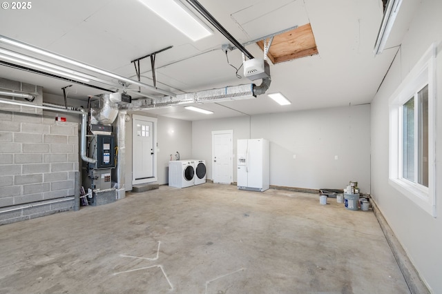 18240 SW Jay St, Beaverton, OR 97003 - garage featuring white refrigerator with ice dispenser, washer and dryer, and heating unit