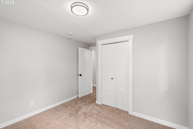 18240 SW Jay St, Beaverton, OR 97003 - unfurnished bedroom featuring light colored carpet, a closet, and a textured ceiling