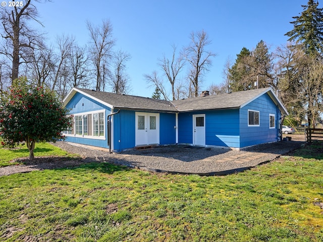 back of property featuring fence and a yard