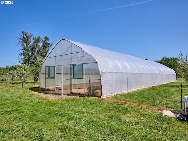 view of greenhouse featuring a lawn