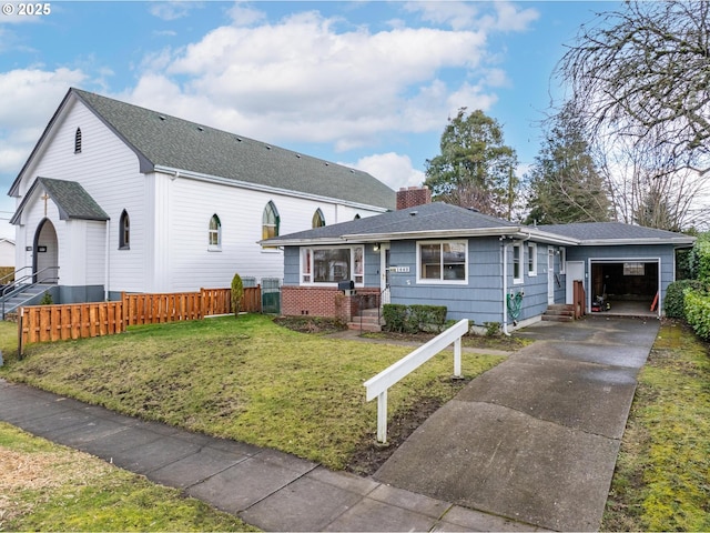 view of front of house with a garage and a front lawn