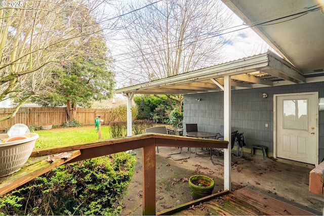 wooden terrace with a lawn