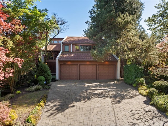 524 Ridgeway Rd, Lake Oswego, OR 97034 - view of front of property featuring a tiled roof, stucco siding, decorative driveway, and an attached garage